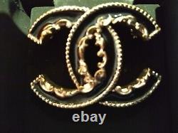 CHANEL Limited Edition! Black enamel and gold metal CC scroll brooch, In Box